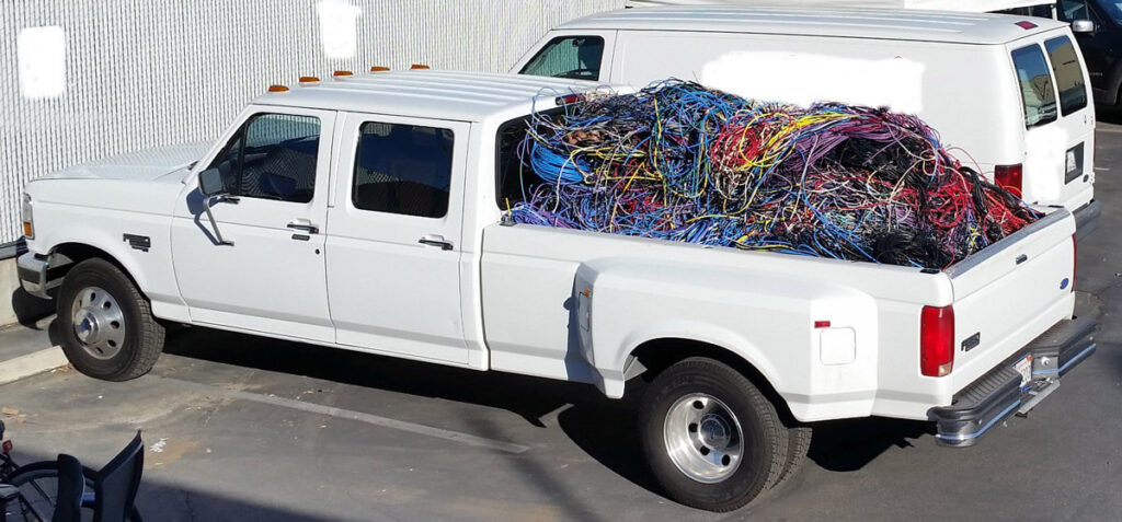 Pick-up truck with flat bed full of wires